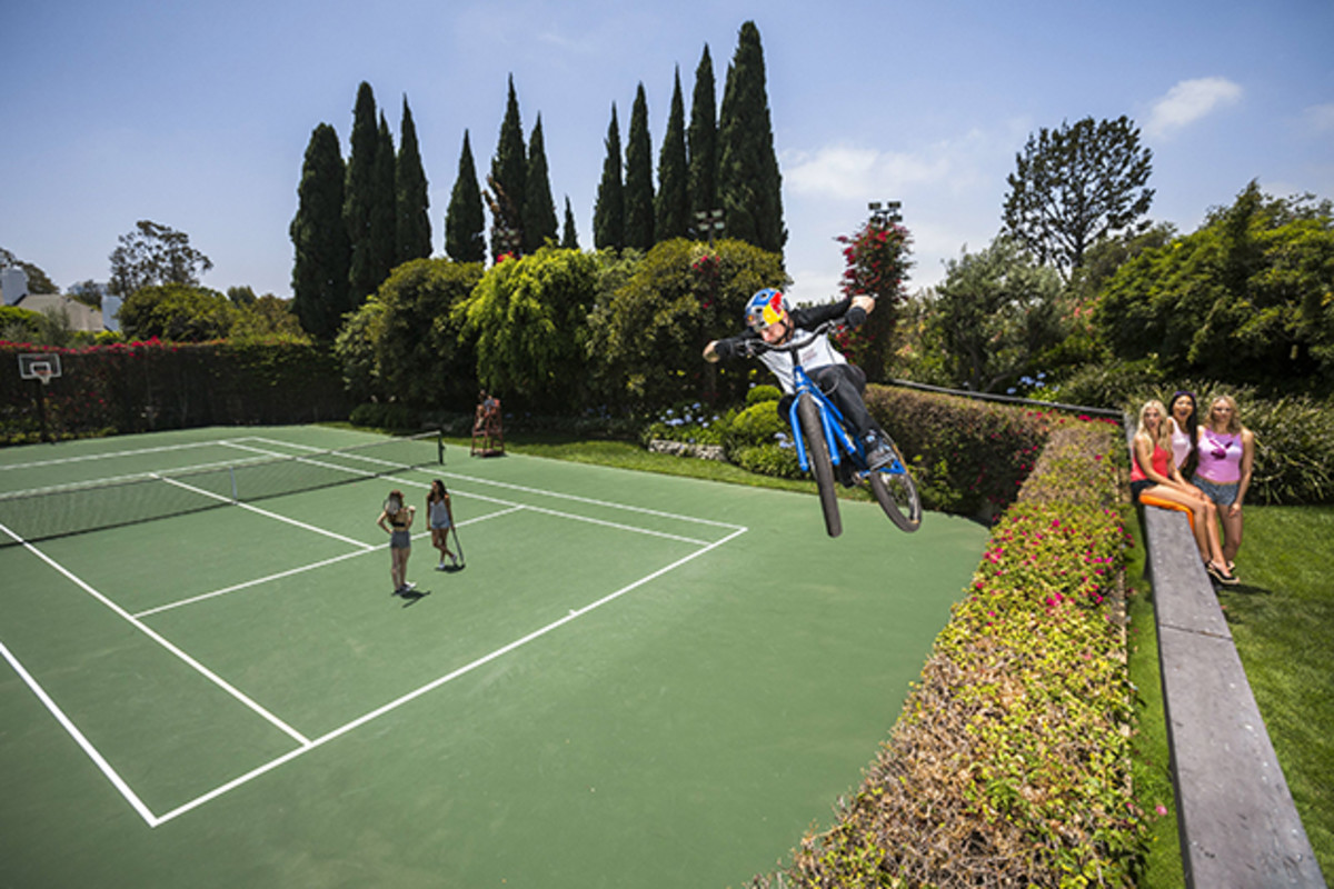Danny MacAskill drops into the tennis court at Hugh Hefner's Playboy Mansion. Photo by Garth Milan/Red Bull Content Pool.