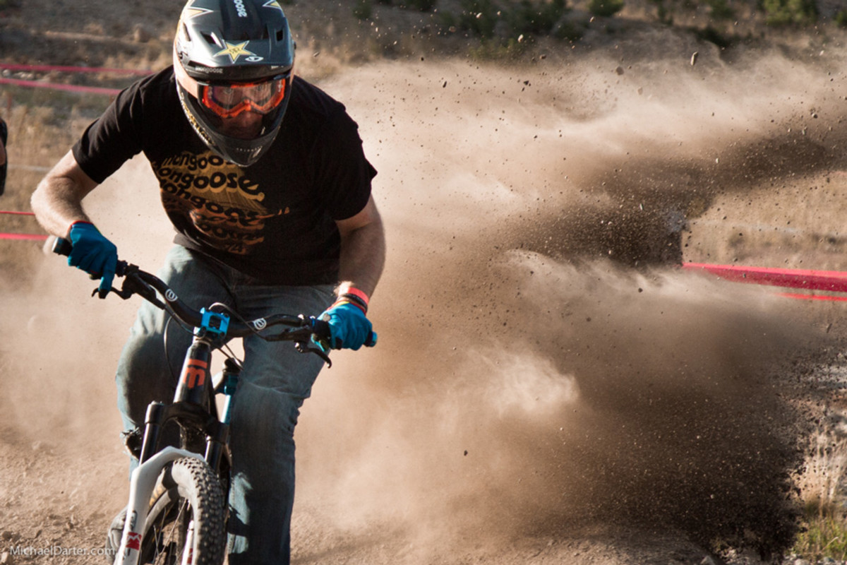 Course designer and builder Greg Watts literally detonates a berm and gets eliminated early in the Speed and Style competition at Mammoth Mountain's 2014 Kamikaze Bike Games. Photo by Michael Darter.