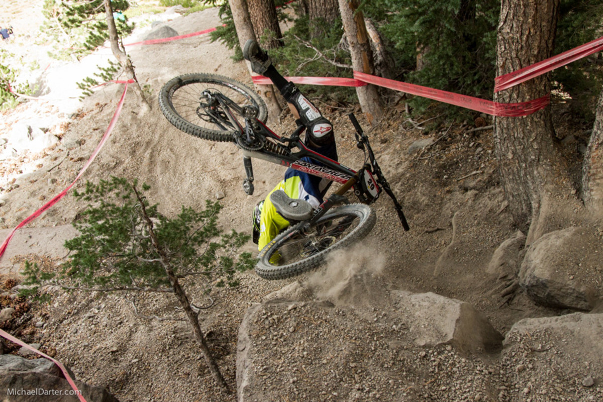 Chris Higgerson ejected out of a rock garden and somehow managed to avoid injury during the Pro GRT downhill race at Mammoth Mountain's 2014 Kamikaze Bike Games. Photo by Michael Darter.