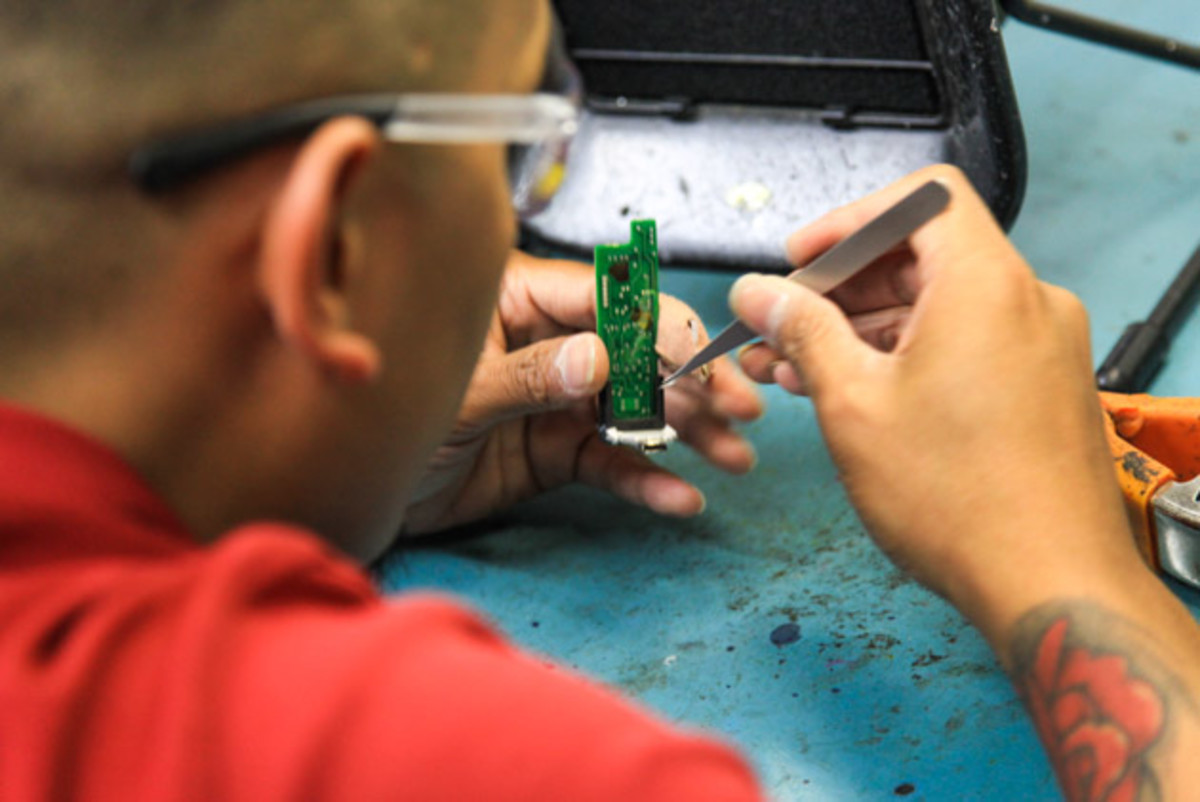 Carl Camacho works on a repair Friday.