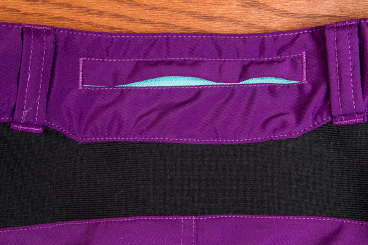 A third zippered pocket on the back waist provides one more place to stash cash or keys, and the stretch fabric below prevents bunching and the dreaded back gap.