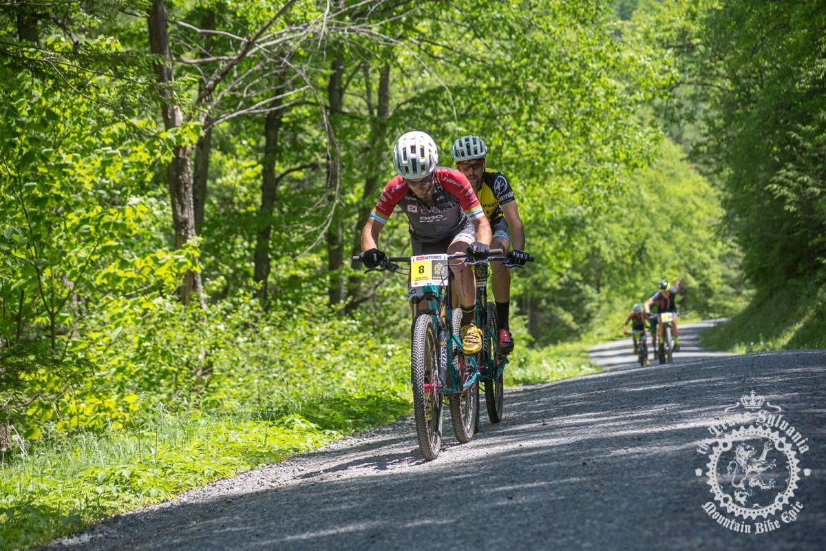 Justin Lindine (Competitive Cyclist) and Payson McElveen (Competitive Cyclist) make a break on a gravel road climb.