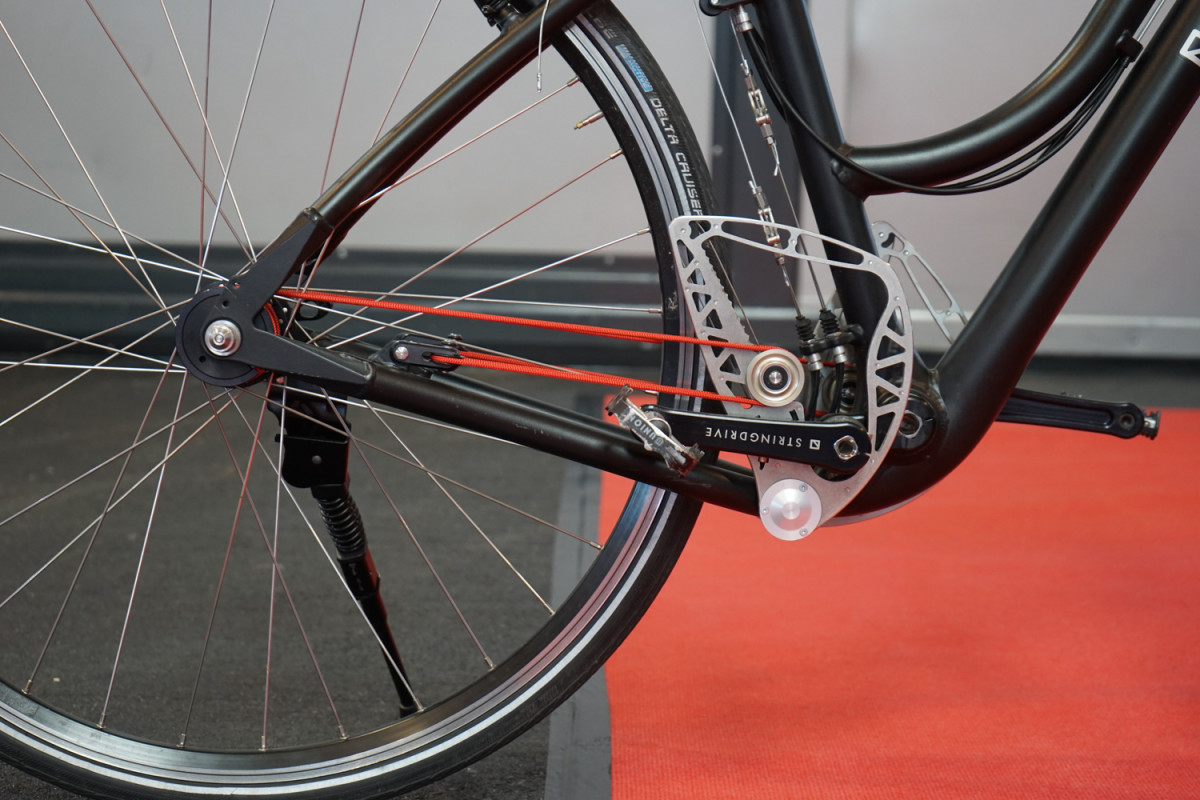 Stringbike guy: "It's good because it doesn't require lubrication, and it's completely symmetrical." Me: "What's beneficial about symmetry?" Stringbike guy: (pause) "and also, you can just carry extra strings as replacements."