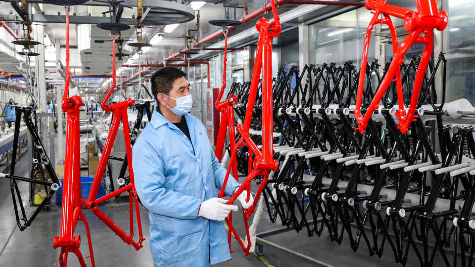 A worker is processing parts for a bicycle frame at a workshop in Huai'an, Jiangsu Province, China, on December 13, 2023. (Photo by Costfoto/NurPhoto via Getty Images)