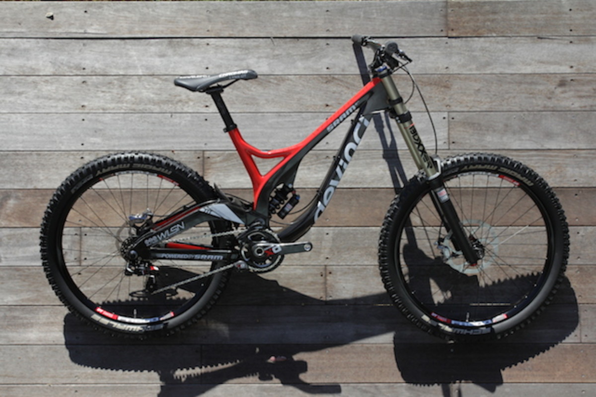 The new SRAM X01 DH drivetrain I rode was fitted to a Devinci Wilson, a thoroughbred downhill bike. The Wilson has a high pivot point so experiences enough chain length growth when the suspension is compressed that it should be run with the medium cage derailleur. Having a little more cage length means there is more chain held in the system which can help accommodate growth.