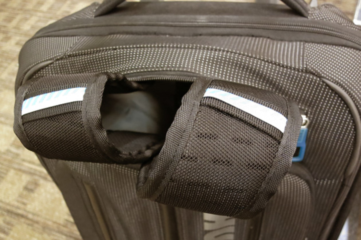 When it comes to toting the Thule around, it's easiest to employ the telescoping handles to roll the bag along, but the Thule 38L also comes with these hide-a-way shoulder straps, which enable you to also carry the bag backpack-style.
