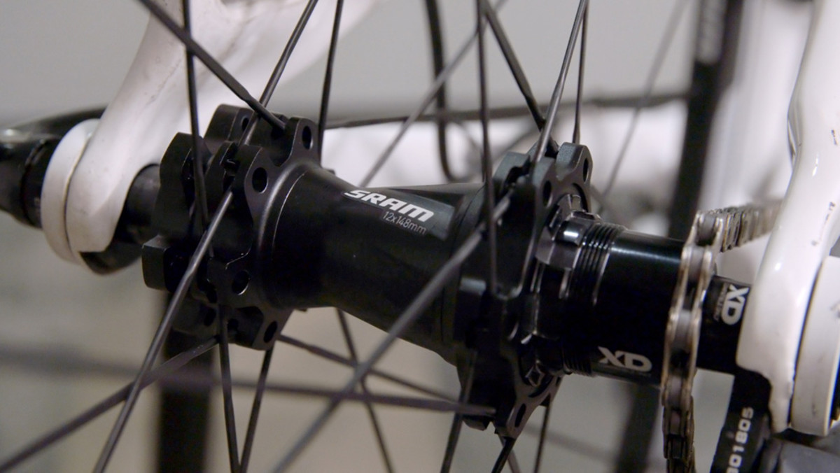 Boost 148 is a rear axle standard that widens the hub shell, effectively pushing each flange outwards by three millimeters, which both improves the spoke bracing angle and increases tire clearance.