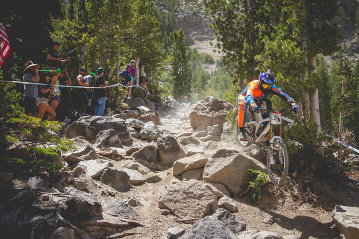 This particular rock might have caused more crashes than any other portion of the course. Here Zach Graveson finds the right line.